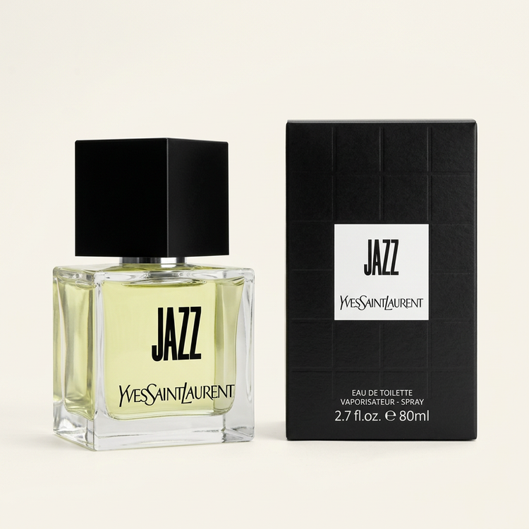 Yves Saint Laurent Jazz Eau de Toilette spray bottle with pale yellow liquid and a black cap, shown next to its black textured packaging box on a light beige background.